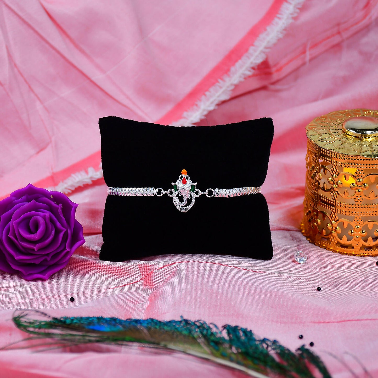 Stylish Ganesha Rakhi With Enamel Highlights And Silver Metal Chain