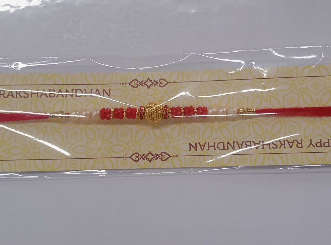 Classic Red Bead Rakhi With Central Golden Textured Bead And Pearl Accents  Elegant Raksha Bandhan Thread For Brother